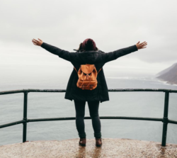 Woman standing at the edge of a large body of water